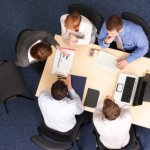 business woman making presentation to group of people